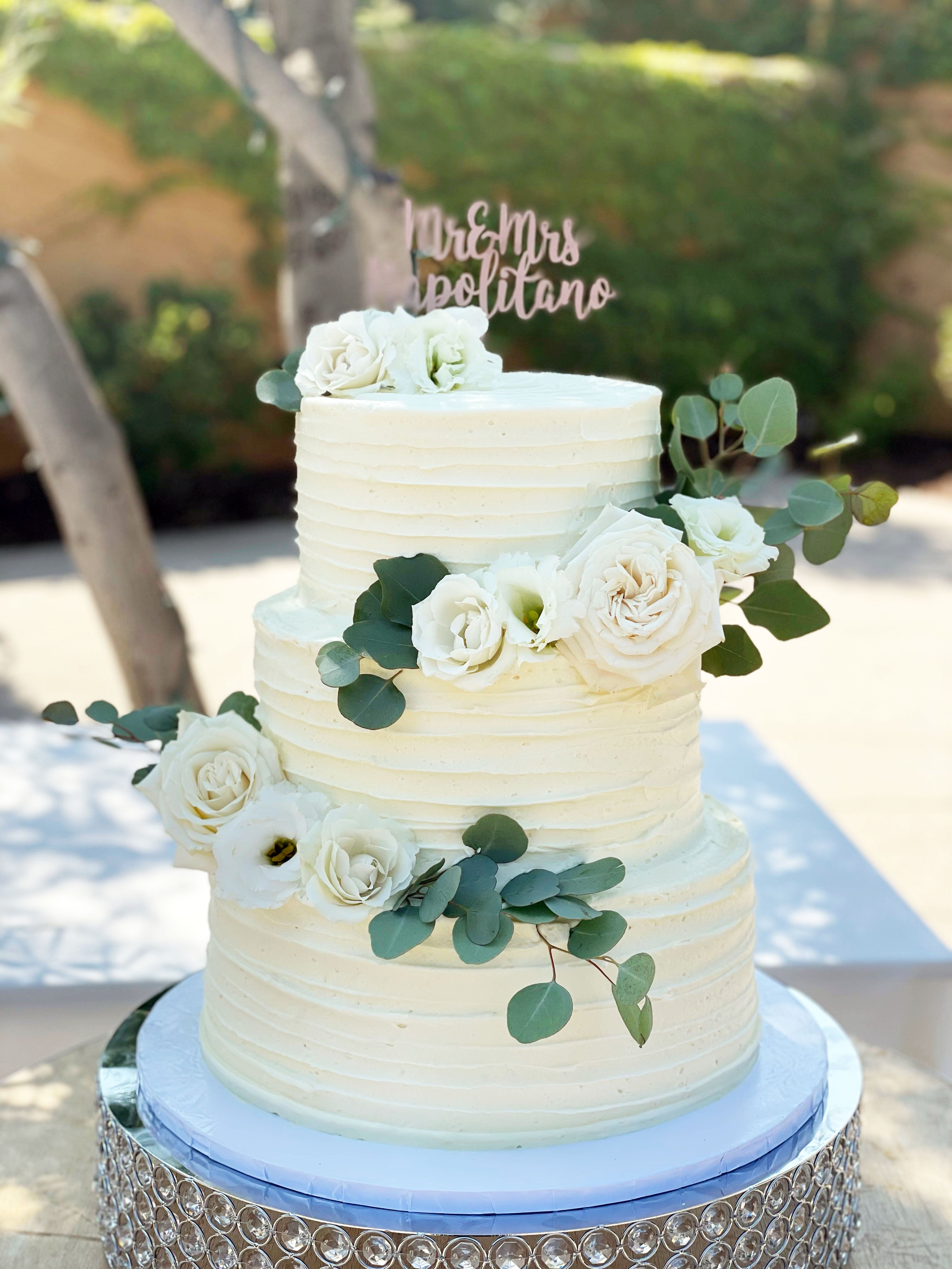 vegan wedding cake with white flowers eucalyptus 
